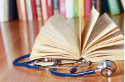 An open book next to a stethoscope